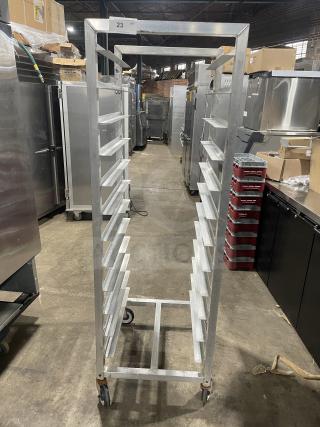 Commercial aluminum 12-pan rack by Alexander Industries, heavy-duty, on casters, excellent condition, ideal for bakery use.