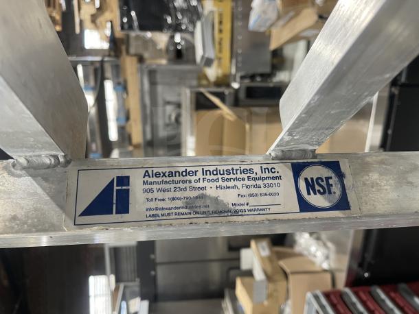 Alexander Industries aluminum 12-pan sheet rack, heavy-duty, on casters, featuring manufacturer's label.