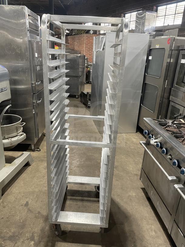 Alexander Industries aluminum 12-pan rack on casters, commercial use, heavy-duty, excellent condition, ideal for bakeries.