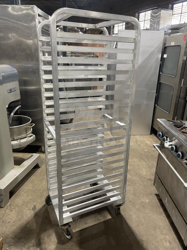 Commercial aluminum 12-pan rack by Alexander Industries on casters, heavy-duty, excellent condition, ideal for bakery use.
