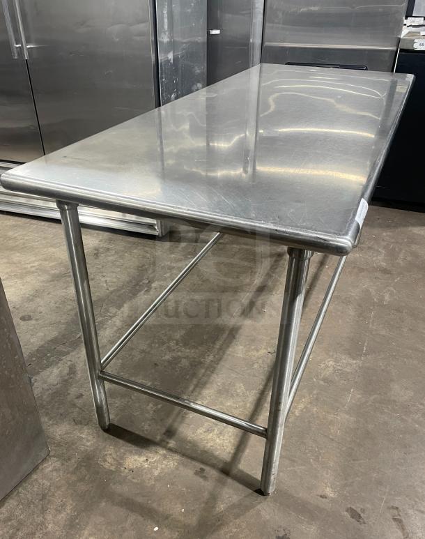 Stainless steel work/prep table in excellent condition, sturdy frame, smooth surface, suitable for kitchen or industrial use.