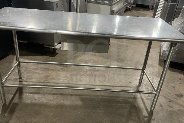 Stainless steel work/prep table, excellent condition, smooth surface, sturdy frame, ideal for commercial kitchens.