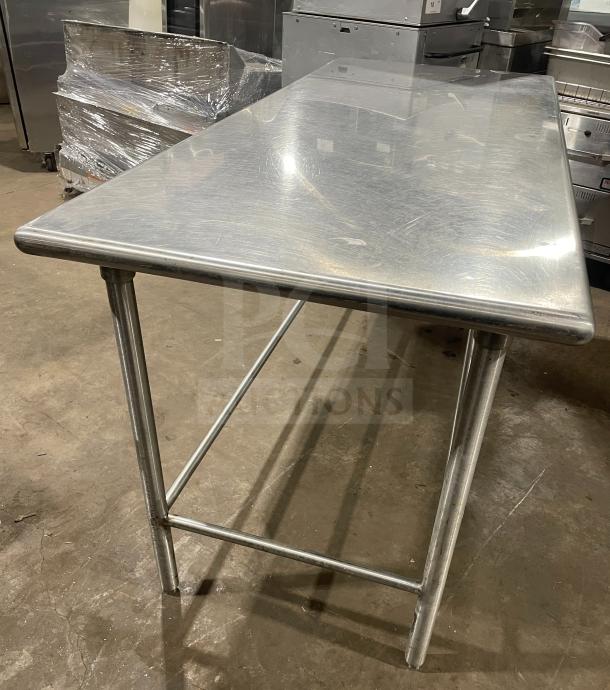 Stainless steel work/prep table, used, sturdy frame, smooth surface, suitable for kitchens or workshops.