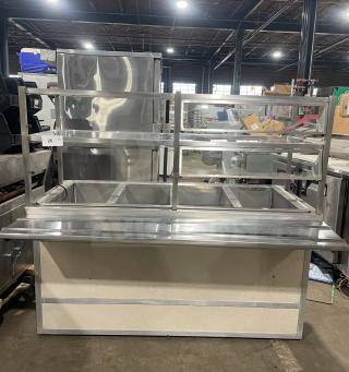 Alt text: Atlas Metal Industries stainless steel buffet-style hot food table, model WCM-BT-4, with sneeze guard, tray slide, and storage cabinet.