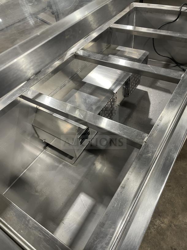 Atlas Metal Industries stainless steel buffet steam table, Model WCM-BT-4. Features sliding door sneeze guard, tray slide, storage cabinet, on casters.