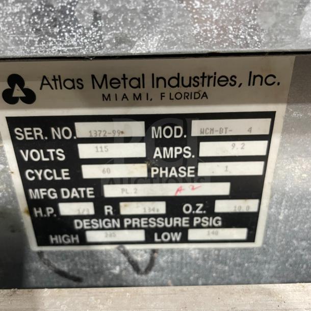 Atlas Metal Industries label showing Model: WCM-BT-4, Serial No: 1372-99, 115V, 1 Phase, on a custom stainless steel steam table.