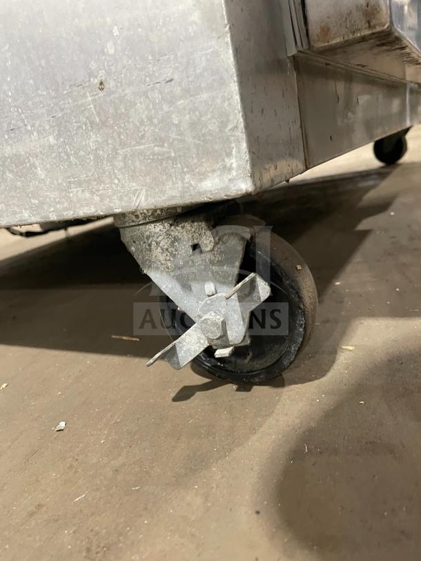 Continental 2R stainless steel 2-door reach-in refrigerator on casters, featuring poly-coated wire racks. Serial: 147A2403.