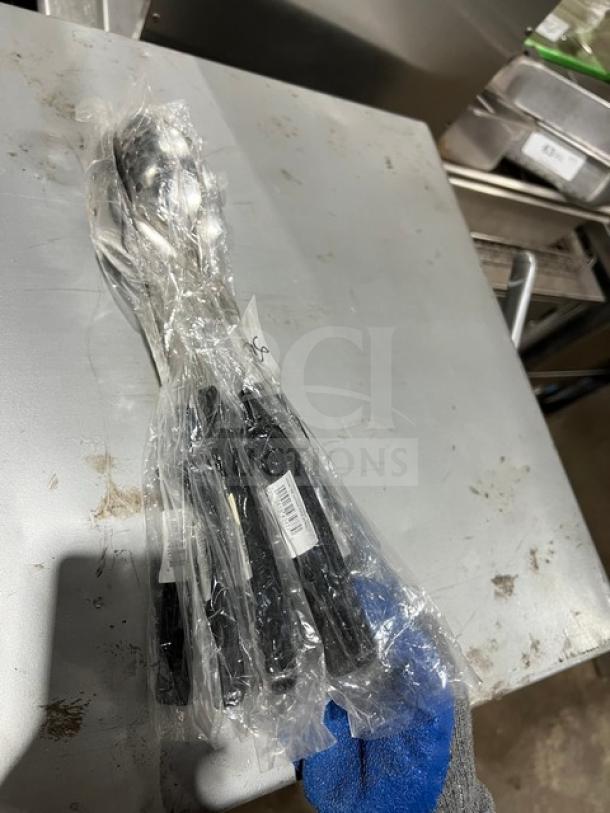 Vollrath 46946 stainless steel perforated spoodle with black grip, packaged in plastic, new condition.