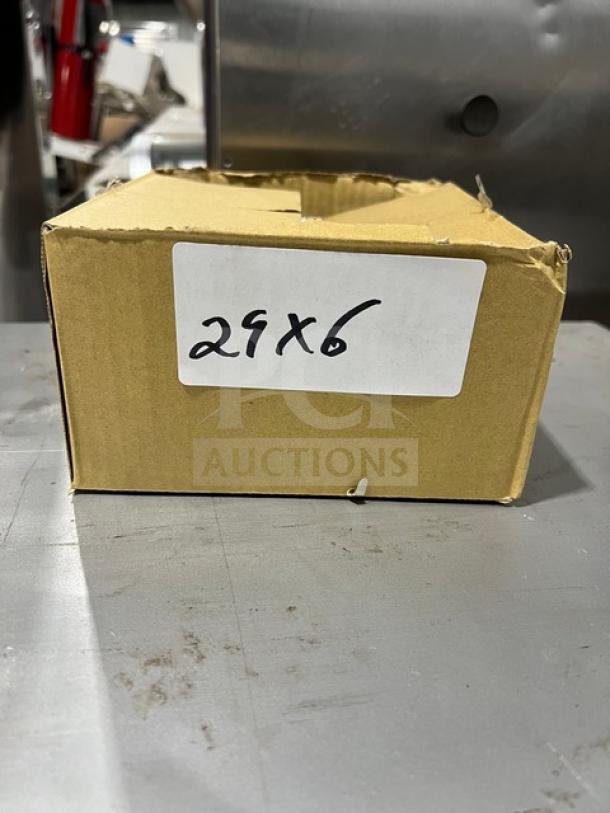 Cardboard box labeled "29x6" containing a brand new Jimmy John's commercial stainless steel dough scraper with a white grip handle.