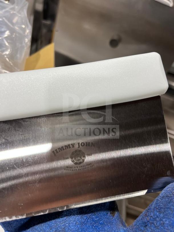 Jimmy John's stainless steel dough scraper/cutter with white grip handle, brand new.