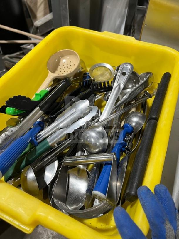 Assorted Winco commercial kitchen hand tools in yellow bin, model TR34W, used for food prep and service. Mix of utensils.