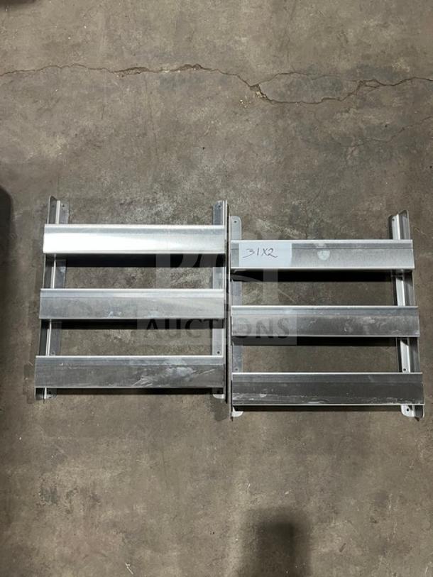 Commercial side smokers/refrigeration racks, metal, set of two, good condition, markings "31X2" visible on one rack.