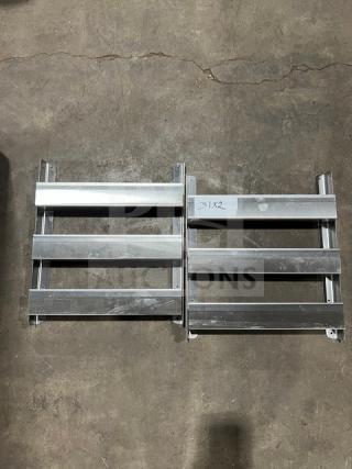 Commercial side smokers/refrigeration racks, metal, set of two, good condition, markings "31X2" visible on one rack.
