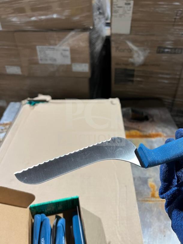 Sysco commercial steak knife with serrated stainless steel blade and blue Ergogrip handle, shown in packaging.