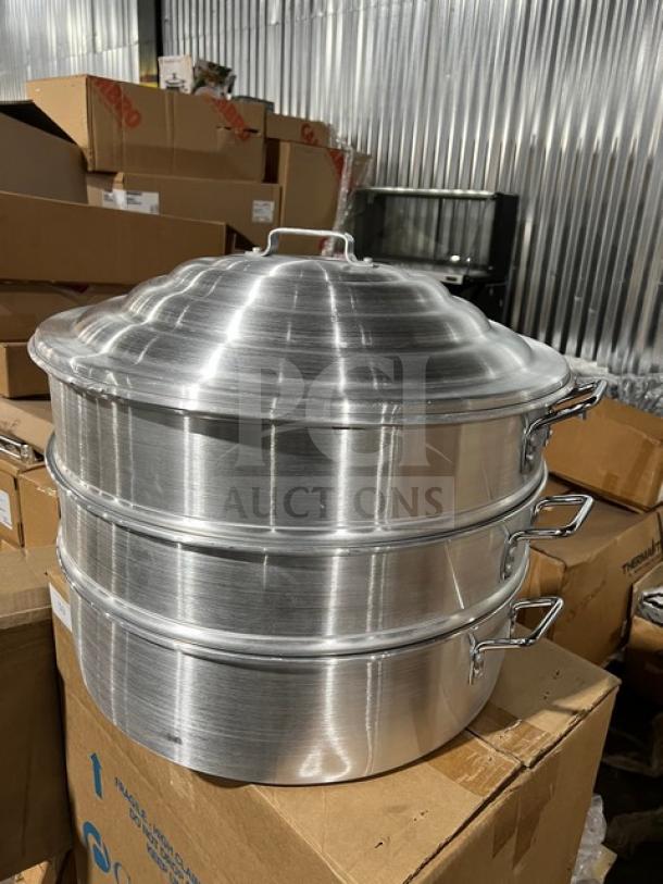New commercial stainless steel food steamer with three tiers; durable construction, shiny finish, brand new condition.
