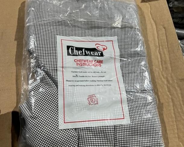 Brand new Chefwear CW3200 chef pants in package, size Large. Black and white checkered. Includes care instructions.
