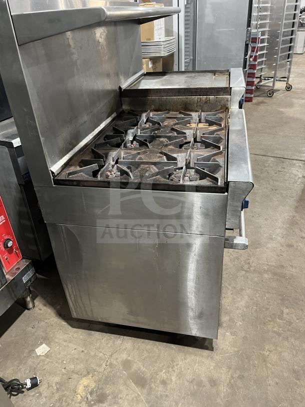 US Range PX-6-24BG-2626 commercial stainless steel 6-burner range with griddle, two ovens, backsplash, salamander shelf, on casters.