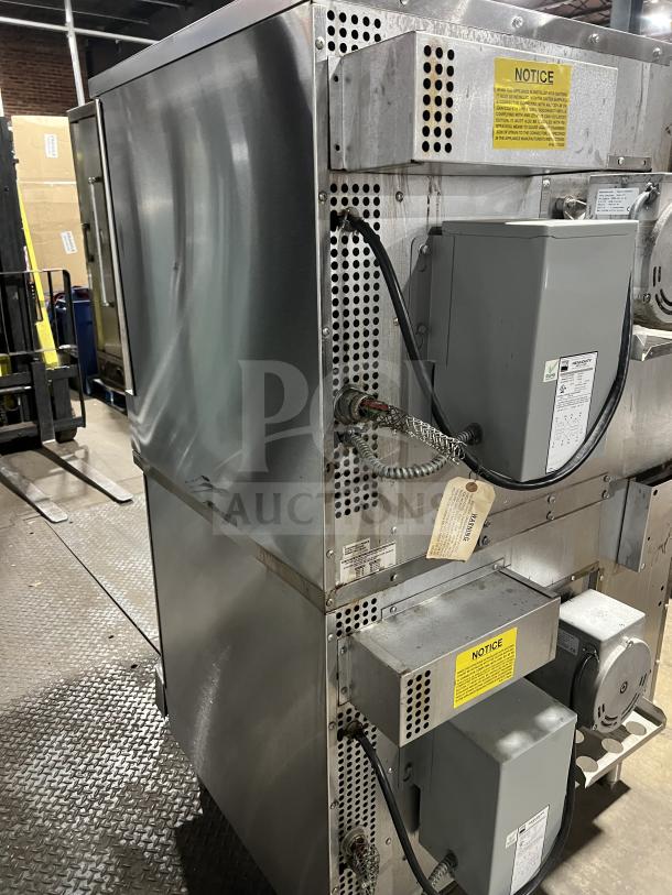 Southbend SilverStar SL-Series double stacked convection oven, model SLES/20SC, stainless steel, electric powered, Energy Star certified, with wired racks and thermostatic controls. Serial number 11H30399-2, on legs, industrial setting.