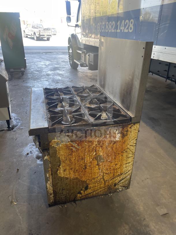 Royal stainless steel 6-burner range/oven combo with backsplash and overhead salamander shelf. Natural gas. Used condition.