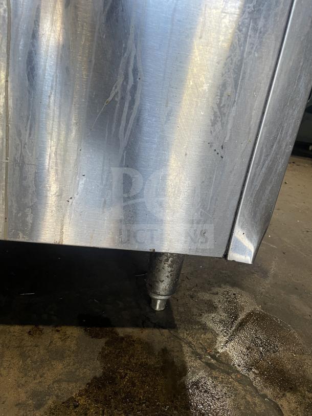 Royal 6-burner stainless steel range/oven combo with backsplash, overhead salamander shelf, and wired oven rack, on legs.