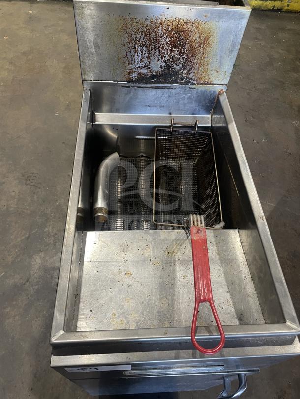 Royal commercial stainless steel floor deep fat fryer with backsplash. Includes one frying basket. Moderate wear visible.