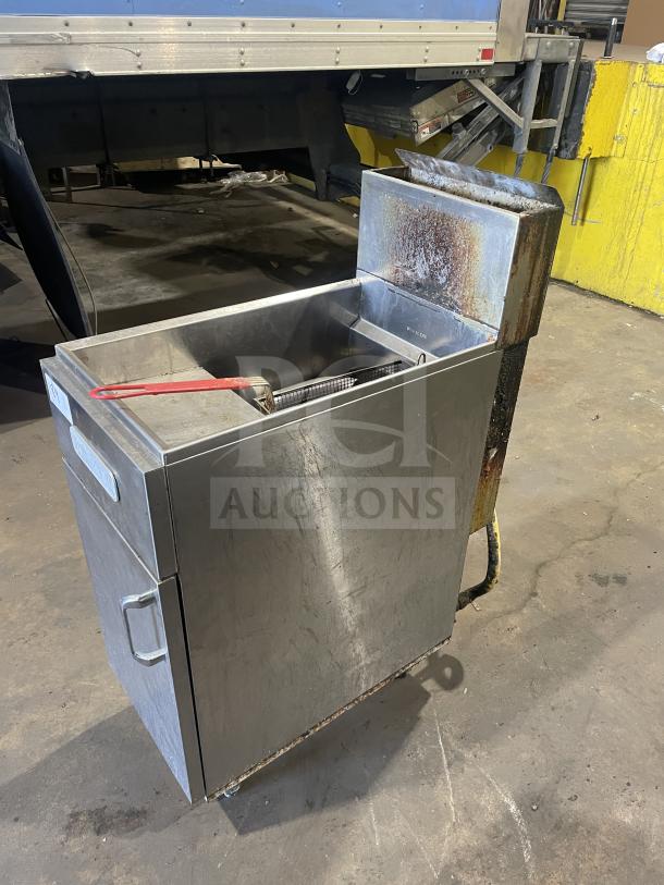 Royal commercial stainless steel deep fat fryer, natural gas powered, floor style with back splash, frying basket included, on casters.