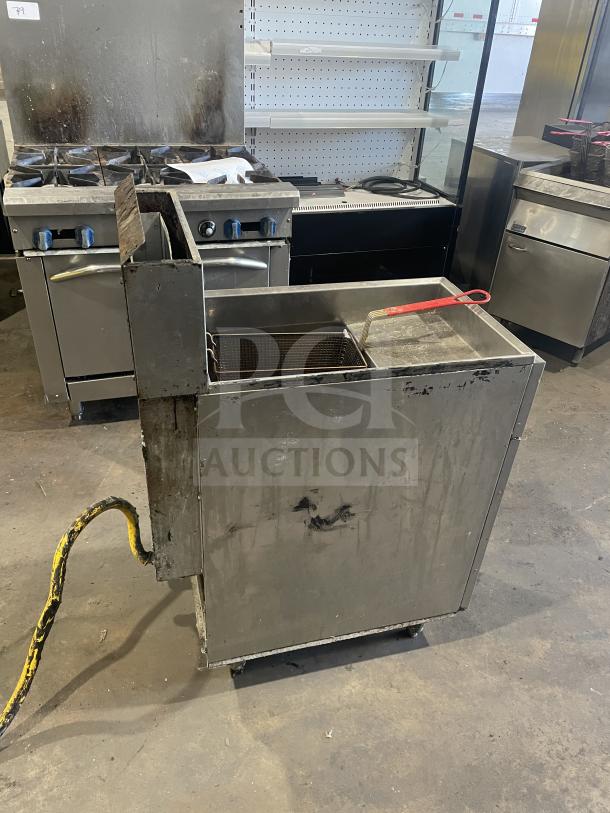 Royal commercial stainless steel natural gas fryer with backsplash, one basket, on casters.
