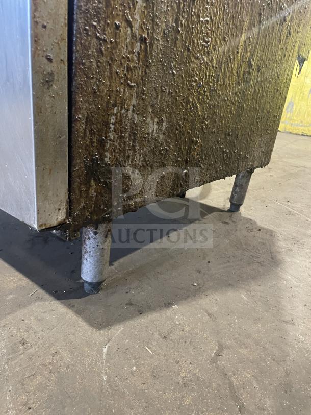 Pitco Frialator commercial gas fryer, stainless steel, with backsplash, basket hanger, and legs. Shown with visible wear.