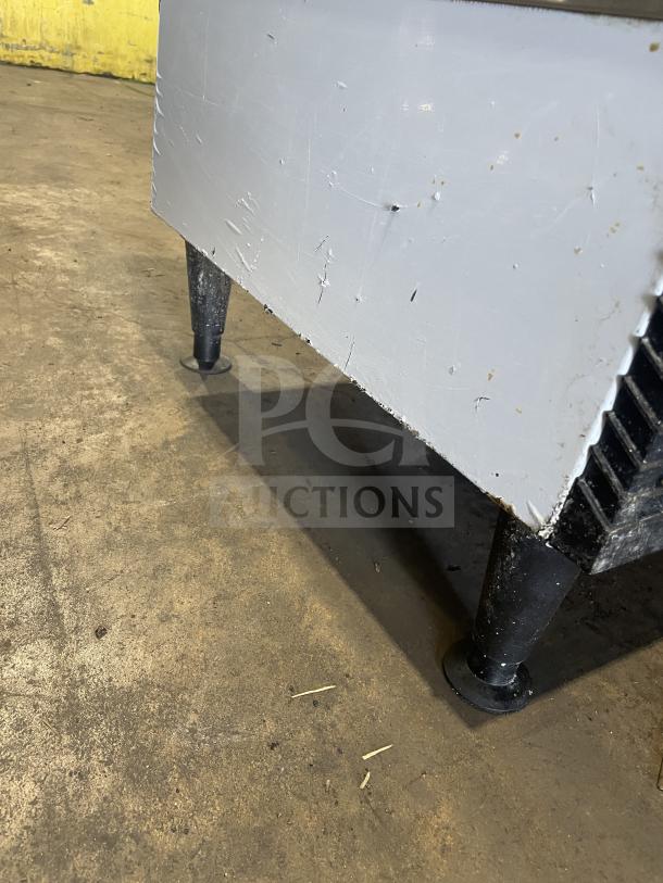 Ice O-Matic ICEU220HA3 commercial ice maker, on legs, shows moderate wear. 115V, 1 Phase. Scratches visible on exterior.