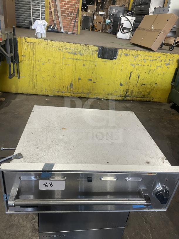 Viking stainless steel commercial electric warming drawer, used, with control knob and label marked "88" indicating identification.