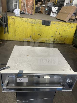 Viking stainless steel commercial electric warming drawer, used, with control knob and label marked "88" indicating identification.