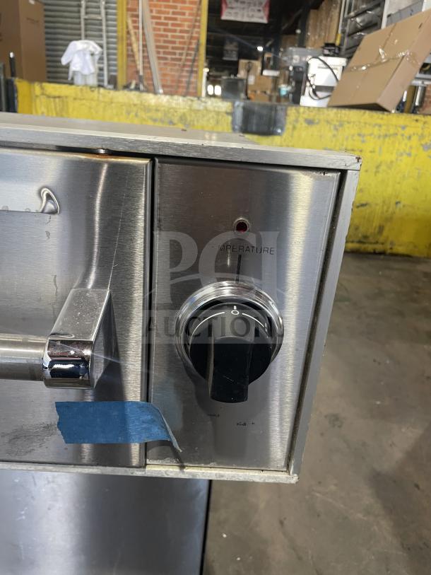Viking stainless steel warming drawer with temperature control knob, minor wear visible, suitable for commercial use.