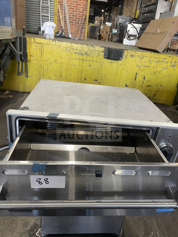 Viking stainless steel commercial electric warming drawer, open view. Visible label "88" indicates item number.