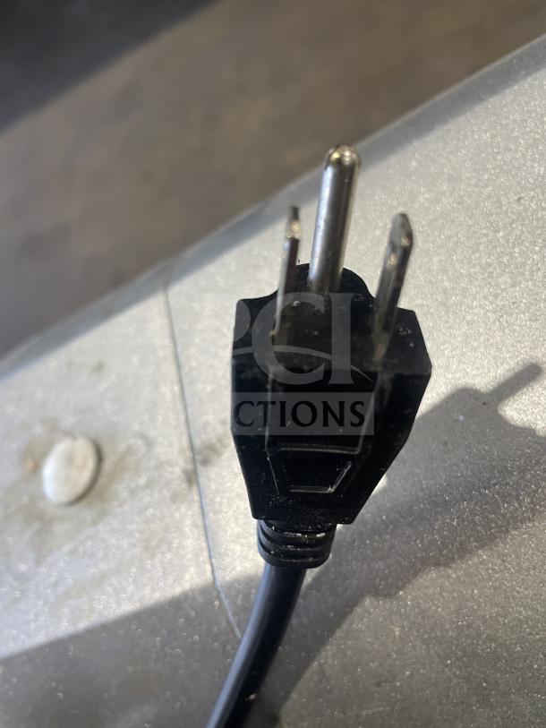 A close-up of the power plug for a commercial planetary mixer, model B3OB, 110V 1 Phase, shown on a textured surface.