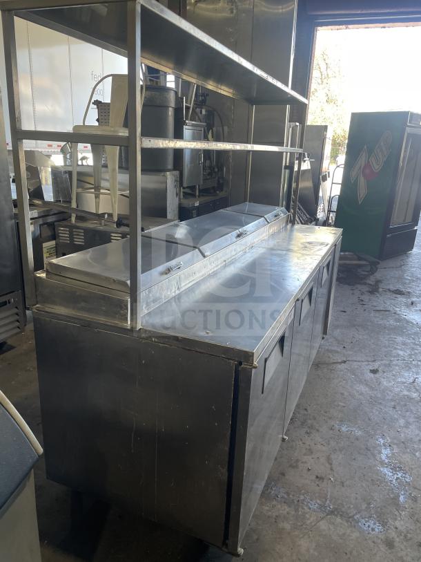 True TTP-93 3-door refrigerated pizza prep table, stainless steel, on casters, model SN: 1-2827290, 115V 1-phase, good condition.