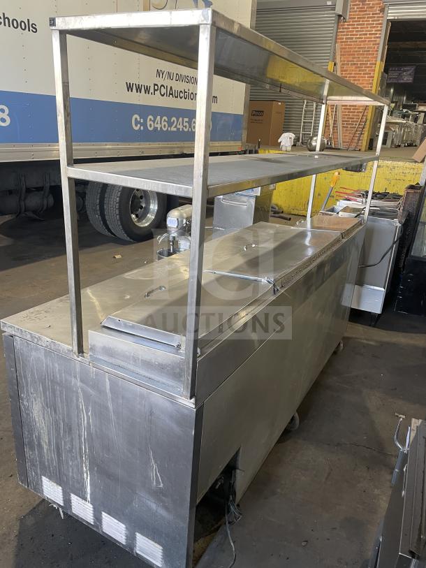 True TTP-93 refrigerated 3-door stainless steel pizza prep table on casters. Features mega top, 115V, 1 phase. Good condition.