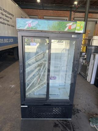 Universal MC1100S-1-SU-64 commercial beverage cooler with 2 sliding glass doors, 7UP branding, and serial number 3409S21496.
