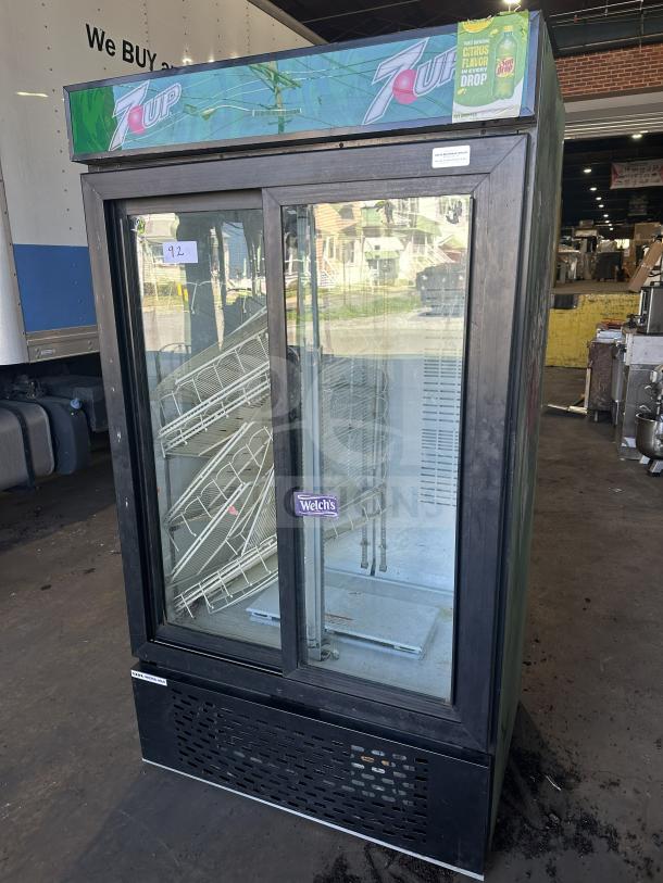 Universal Nolin commercial beverage cooler, model MC1100S-1-SU-64, with 2 sliding glass doors, 120V, featuring 7-Up branding.