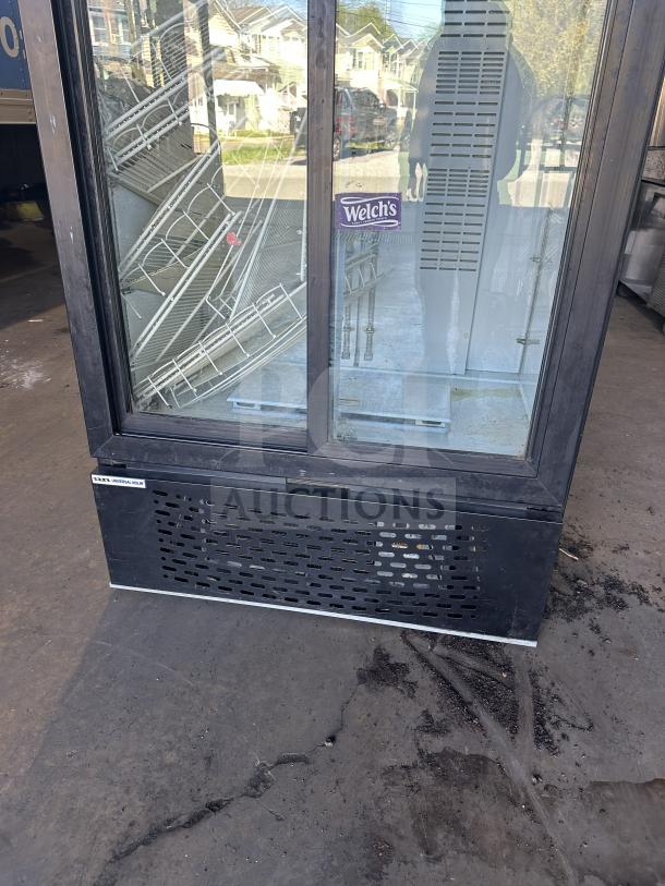 Universal Nolin MC1100S-1-SU-64 beverage cooler, 2 sliding glass doors, 120V, 1 phase, commercial use, visible Welch's label.