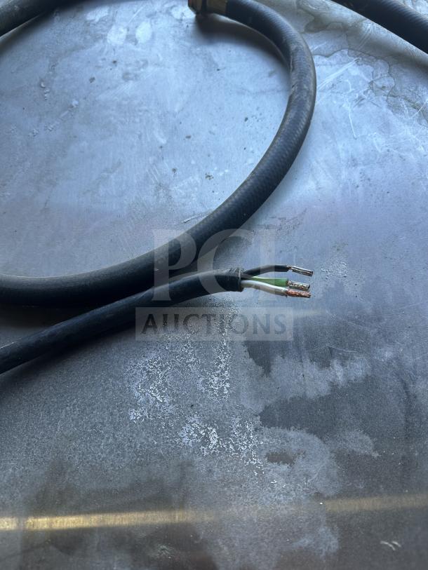 Close-up of a power cable, part of a Jackson DishStar commercial dishwasher, model DISHSTARHT, focusing on wiring details.