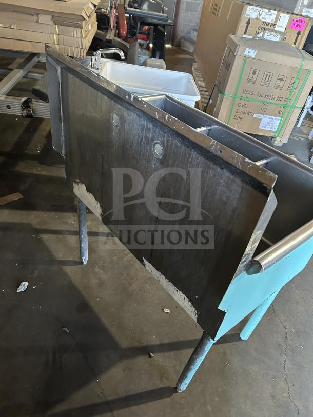 Commercial stainless steel teal bar sink with three compartments and sturdy legs. Good condition, ideal for restaurant use.