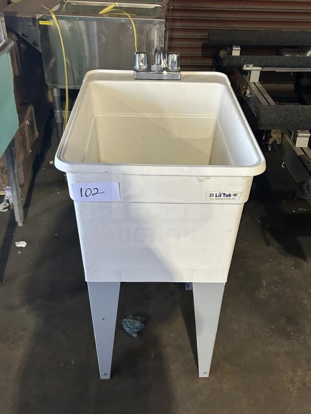 Mustee Liltub commercial laundry tub with two-handle faucet, on legs. Visible model label and condition is good.