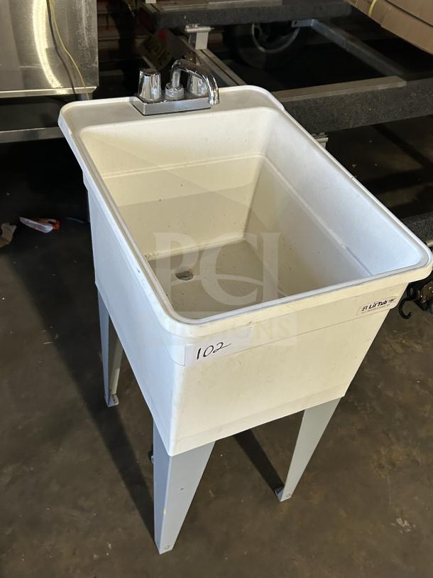 Good! Mustee Liltub single laundry tub with 2-handle faucet, on legs. White finish, in good condition, labeled "102".
