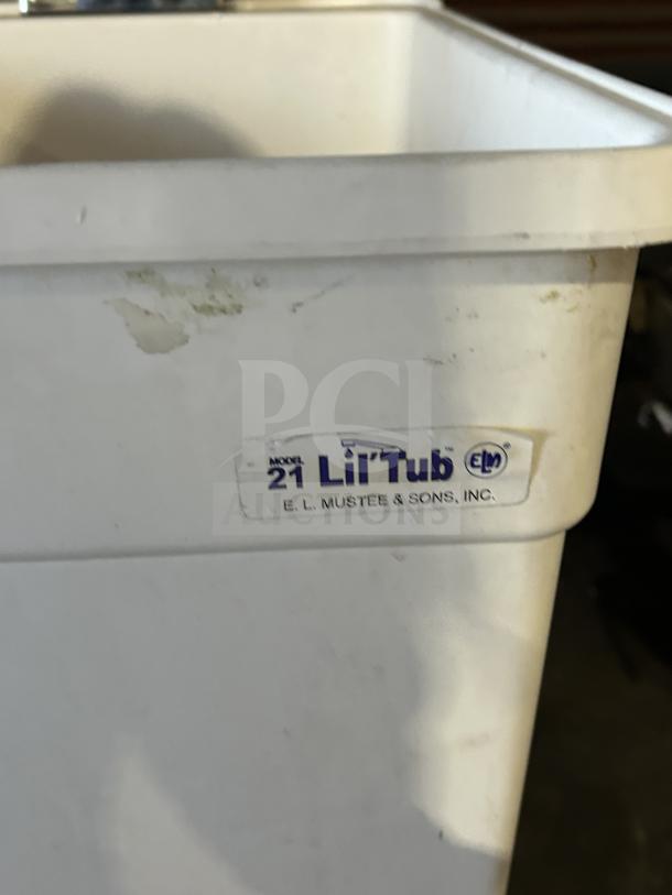 E.L. Mustee Lil'Tub Model 21 laundry tub, white, single basin with 2-handle faucet, on legs, slight marks visible.