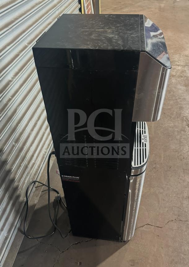 Brio CLBL720SC electric water dispenser, black and silver, showing power cord and drain plug label, in used condition.