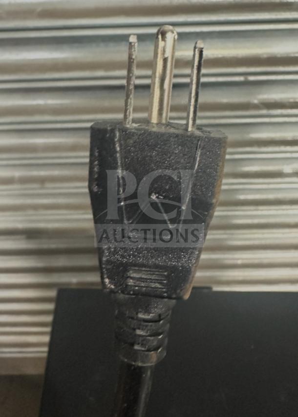 Close-up of a Brio electric water dispenser plug, model CLBL720SC. Features a standard 115V three-prong plug.