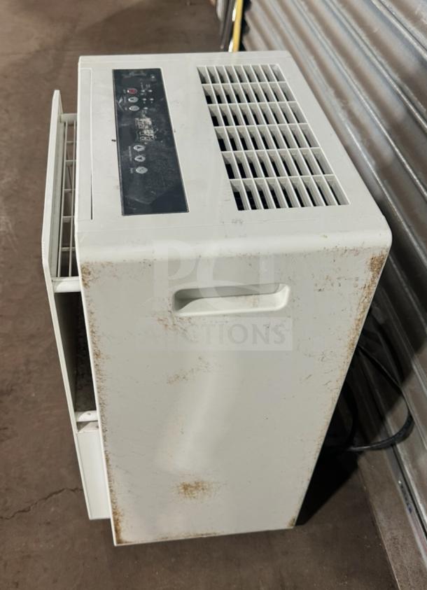 Friedrich D50BP dehumidifier on casters, visible wear, 115V, SN: AFAD00983, shows control panel and side vents.