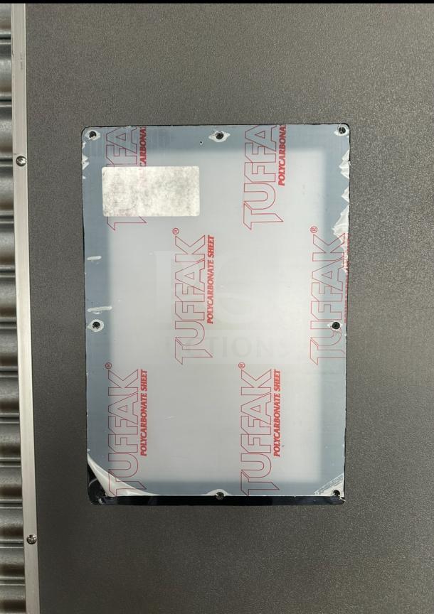 Impacdor refrigerator door with serial number 830160, featuring a Tuffak polycarbonate sheet cover, in excellent condition.