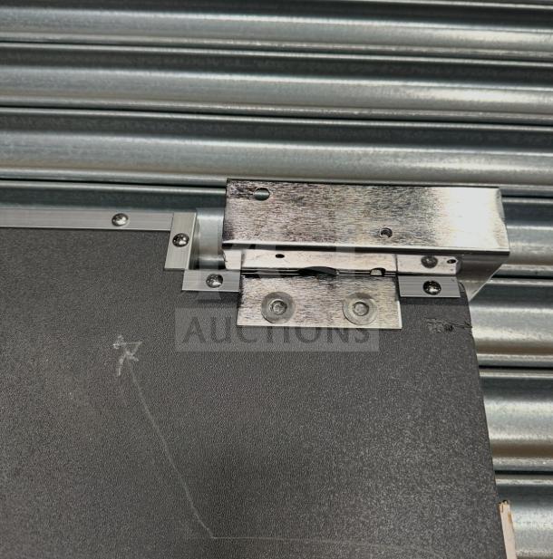 Impacdor refrigerator door, serial number 830160, features metal hinges and screws, in good condition.