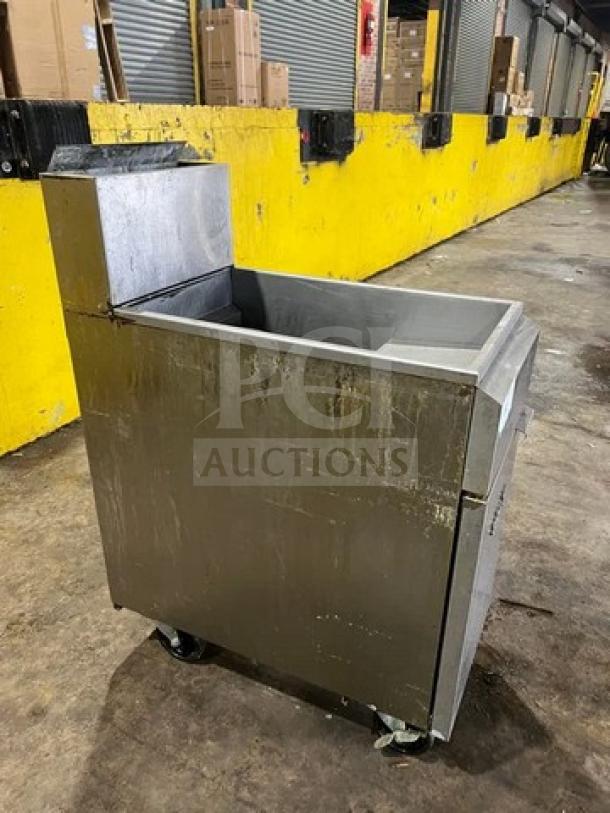 Asber commercial stainless steel deep fat fryer, model AEF-4050-S-E-NG, 40/50 lb. capacity, on casters, with backsplash.